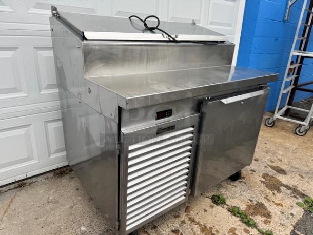 Traulsen 48" pizza prep table, model TS048HT, stainless steel, on casters. Features integrated refrigeration, 115V, tested working.