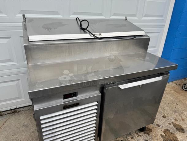 Traulsen 48" pizza prep table, model TS048HT, on casters. Stainless steel, tested & working, 115V. Visible Traulsen logo.