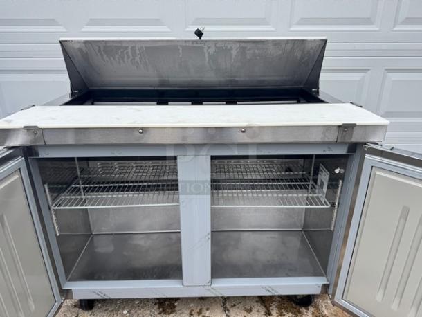 Hoshizaki SR48A-12 two-door sandwich table, stainless steel, on casters, open lid, with shelving, 115V, tested and working.