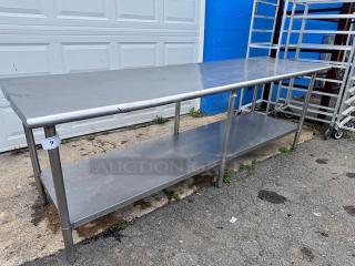 8ft stainless steel work table with undershelf, good condition, industrial use, visible tag marked with number 9.
