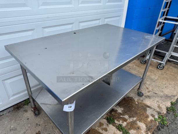 60" stainless steel work table with undershelf, gently used. Features durable construction, on wheels for mobility, label reads "10".