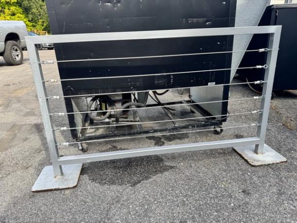 Portable Fence BIDX2 with metal frame and horizontal wires, in good condition, ideal for temporary outdoor barriers.