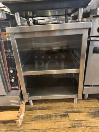 Stainless steel stand with two shelves, industrial grade, excellent condition, dimensions: approx. 30"x24"x36". Ideal for commercial use.