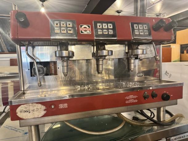Brasilia 205EX FNG DIG3 commercial espresso machine, 230V, three-group, red and stainless steel, Rossi branding, visible wear.
