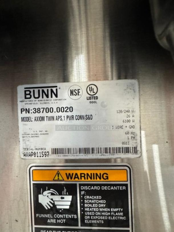 BUNN AXIOM Dual Coffee Brewer label showing model AXIOM, 120/240V, NSF and UL listed, with a warning notice.