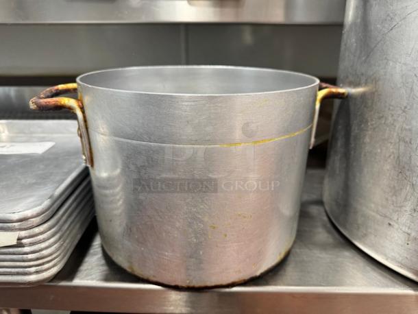 10x8" aluminum stock pot with dual handles, showing signs of wear and minor discoloration, ideal for kitchen use.