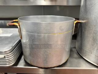 10x8" aluminum stock pot with dual handles, showing signs of wear and minor discoloration, ideal for kitchen use.