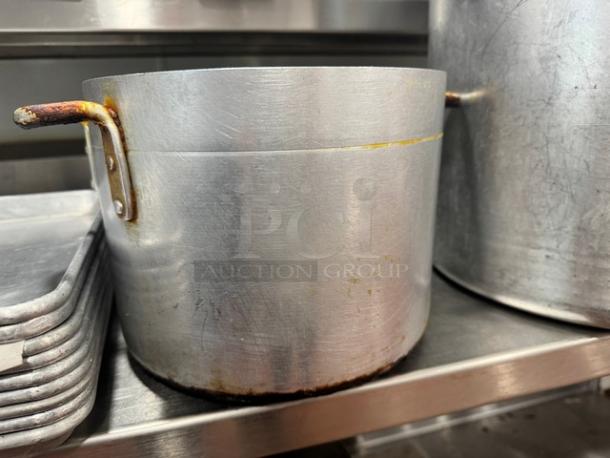 10x8" aluminum stock pot with two handles, visible wear, and slight discoloration. Ideal for cooking, durable material.