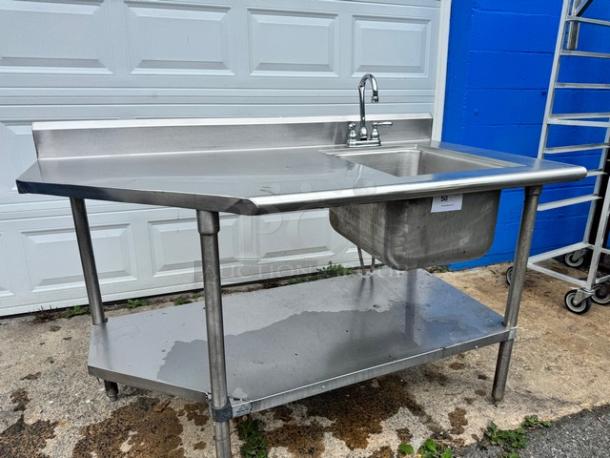 Stainless steel 60" sink and table with lower shelf. Broken faucet present. Ideal for commercial kitchens.