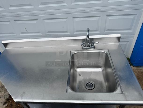 Stainless steel 60" sink and table with broken faucet, minor surface marks, durable design, ideal for commercial use.