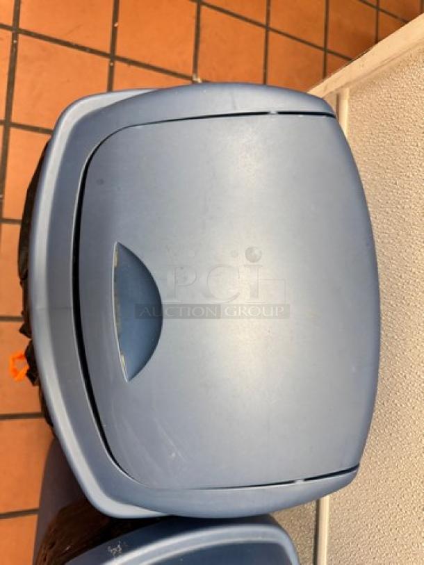 Blue Swing Top Waste Can BIDX2, plastic, good condition, swing lid for easy waste disposal, ideal for kitchen or office use.