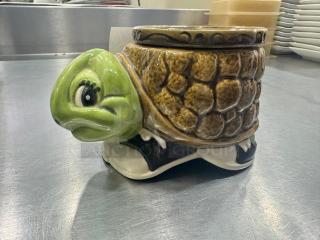 Ceramic turtle figurine with a green head and brown shell. Appears in good condition, no visible markings.