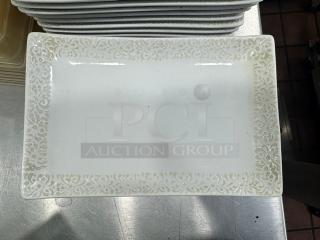 Rectangular porcelain plate BIDX13 with intricate floral border design in mint condition. Stack of similar plates visible.