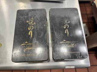 Lot of 2 black aluminum storage boxes with gold Japanese text and designs, marked "TOKYO NORI U.S.A. INC"; shows wear.