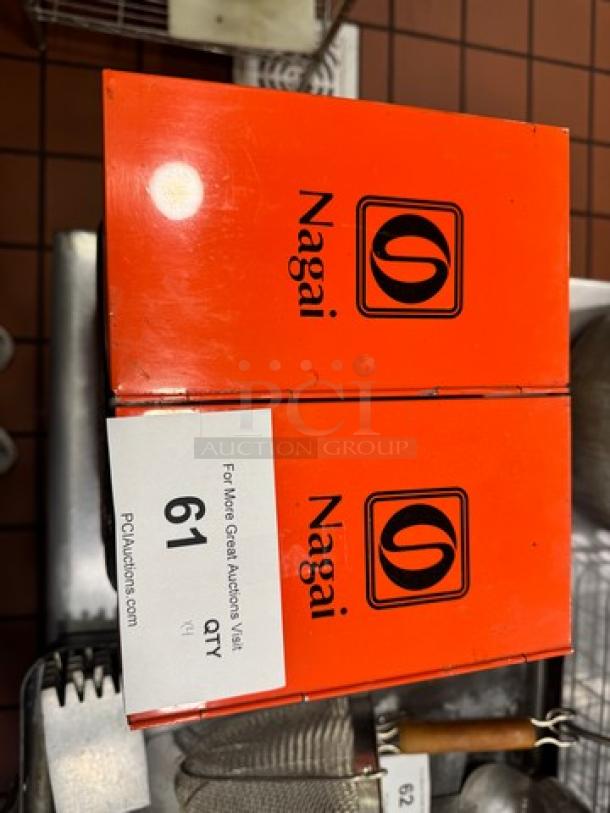 Lot of 4 orange aluminum storage boxes by Nagai, with logo and auction label visible. Good condition.