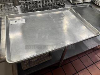 Aluminum baking pan, model BIDX2, in good condition. Features sturdy construction with minor surface wear. Auction label visible.