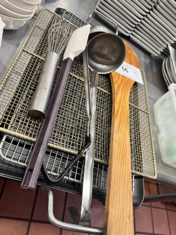 Miscellaneous kitchenware set, including whisk, spatula, ladle, tongs, and wooden spoon on a metal tray. Condition appears gently used.