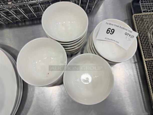 Stack of 4" porcelain sauce bowls, model BIDX36, in good condition. Auction tag reads "69, Qty 36, PCAuctions.com".