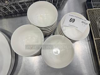 Stack of 4" porcelain sauce bowls, model BIDX36, in good condition. Auction tag reads "69, Qty 36, PCAuctions.com".