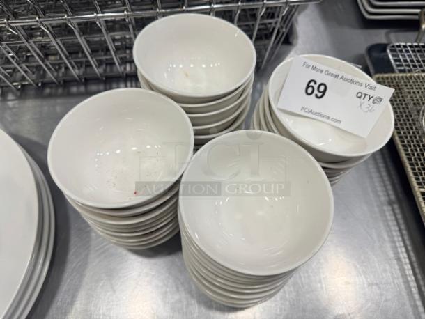 Stack of 4" porcelain sauce bowls, model BIDX36, in pristine condition. Auction label indicates item 69.