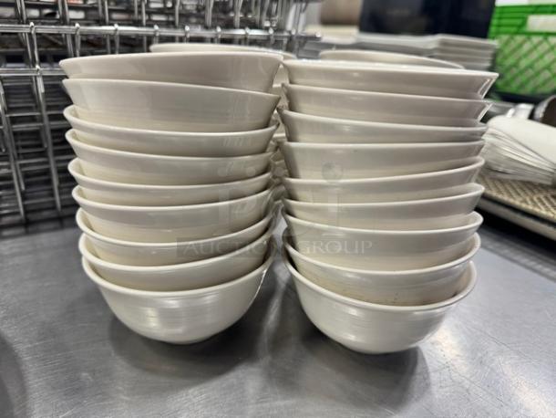 Stack of 4" porcelain sauce bowls, model BIDX36, in white. Appears in good condition with no visible defects.