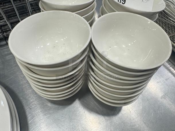 Stack of 4" porcelain sauce bowls, model BIDX36. Bowls are white, appear gently used, with minor surface marks.