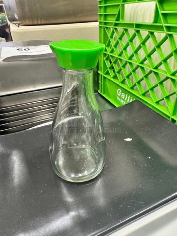 Clear glass soy sauce dispenser bottle with green lid. Item is part of a lot of 11. Clean and in good condition.