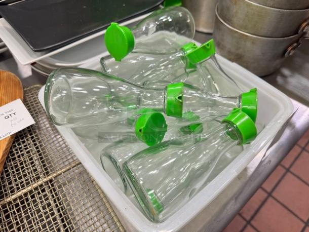 Lot of 11 glass soy sauce dispensers, green flip-top lids, used, clear design, no visible damage, suitable for kitchen use.
