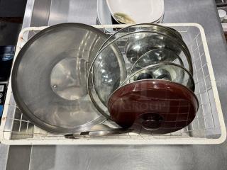 Miscellaneous glass and aluminum pot lids in used condition, various sizes, clear and brown finishes, all for one price.