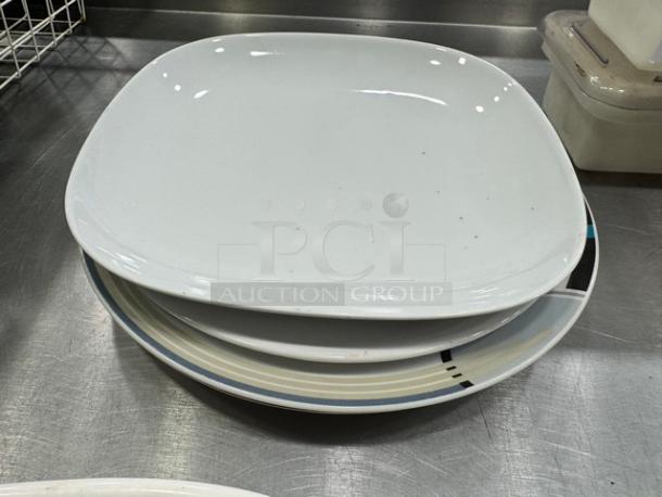 Stack of assorted serving platters, various shapes, and designs. Appears in good condition, sold as a single lot.