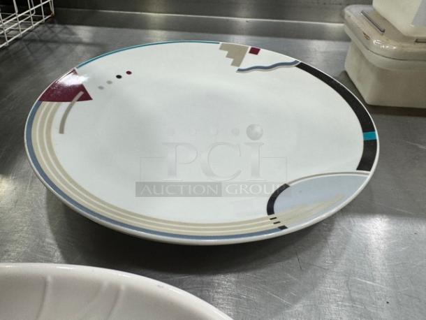 Colorful geometric serving platter with abstract patterns on a smooth surface. In good condition.