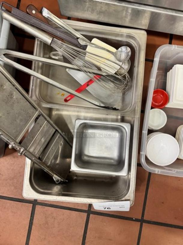 Commercial kitchenware collection, including metal tongs, whisks, spatulas, and pans in used condition, grouped as one lot.