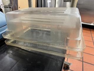 Clear plastic food storage container with lid, textured surface, stackable design. Used condition, minor wear visible.