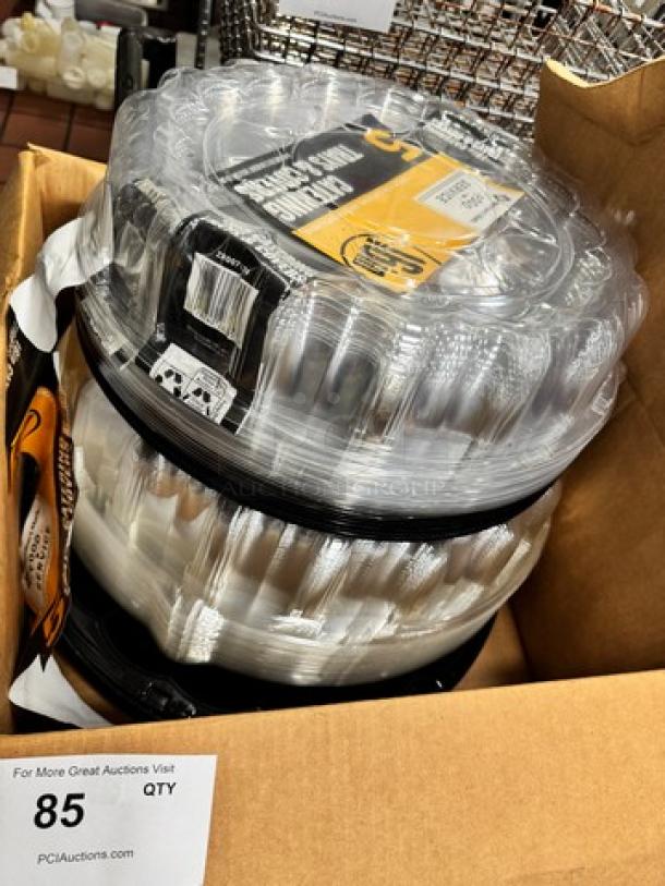Stack of round catering trays with covers, brand new in packaging. Markings indicate quantity: 85 trays. Suitable for events.