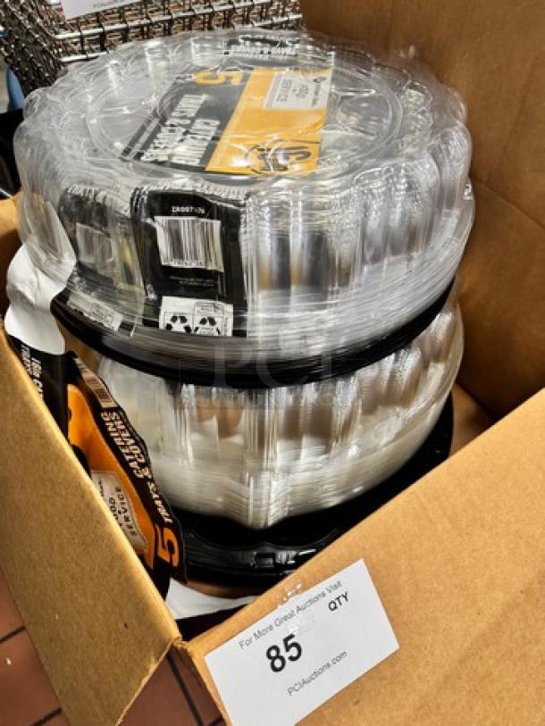 Catering trays with covers in a box, clear plastic, sealed packaging, 85 quantity tag visible, new condition.