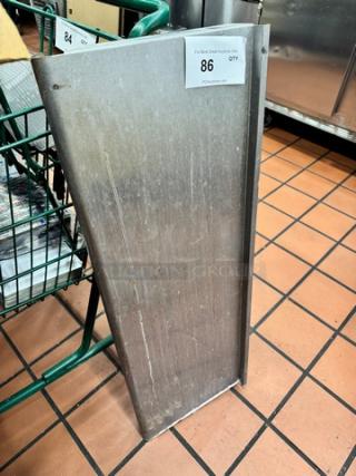 36x12 stainless steel shelf, slightly worn, industrial use. Auction tag: "Lot 86." Durable and functional.