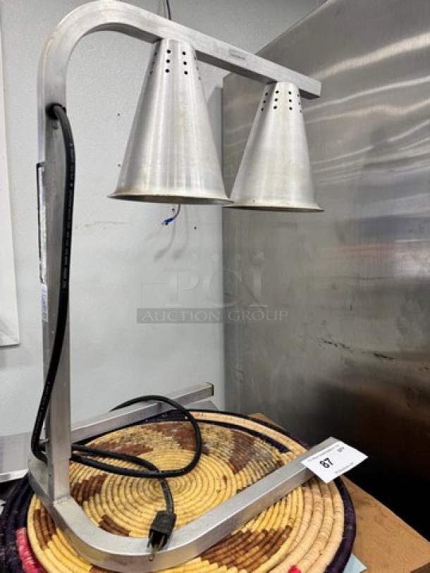 Commercial food heat lamp with dual metal shades, modern design. Plug-in model. Appears in good condition.