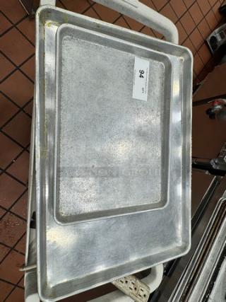 Lot of 2 metal baking trays, used condition, rectangular shape, with visible wear. Label reads "94".