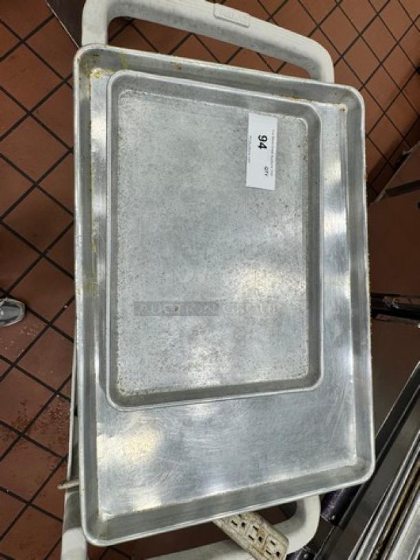Lot of 2 metal baking trays, used condition, slight wear. Number 94 label visible. Ideal for kitchen or bakery use.