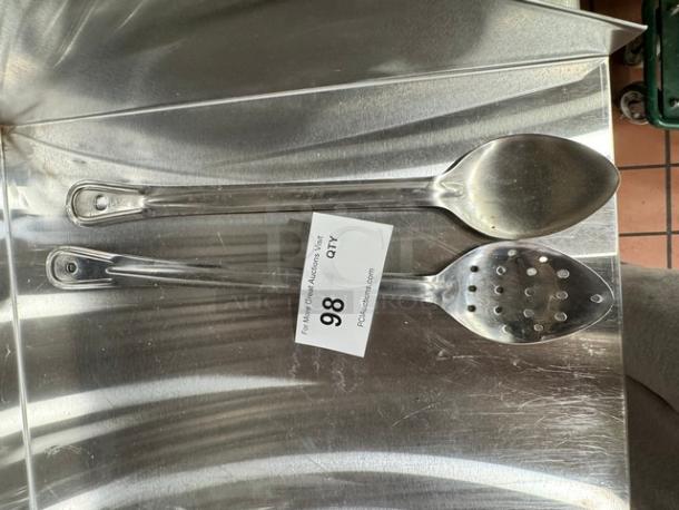 Two stainless steel kitchen spoons, solid and slotted, good condition. Auction tag "Lot 98, Qty" attached.