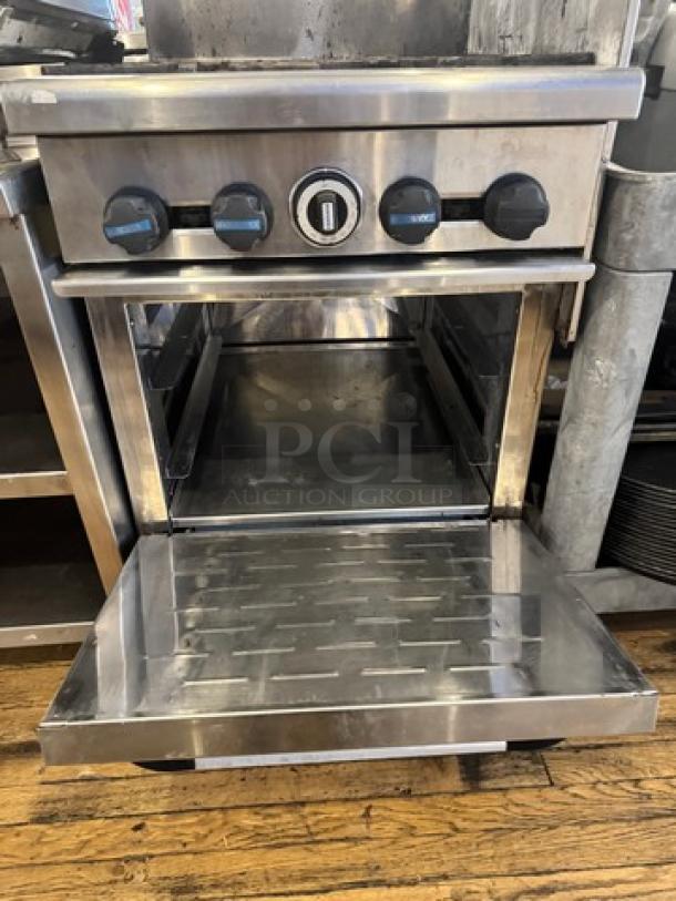 Radiance Natural Gas 4 Burner Stove+Oven on legs. Stainless steel, open oven door, control knobs visible. Used condition.