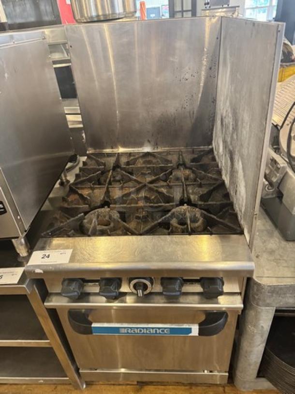 Radiance natural gas stove, 4 burners, with oven, on legs. Used condition, features visible knobs, brand label on front.
