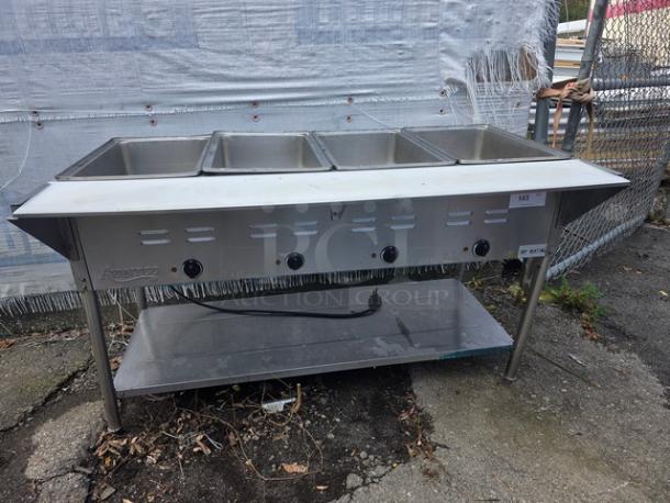 Avantco STE-4SA four pan open well electric steam table with undershelf, stainless steel, moderate wear.