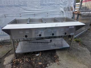 Avantco STE-4SA four pan open well electric steam table with undershelf, stainless steel, moderate wear.