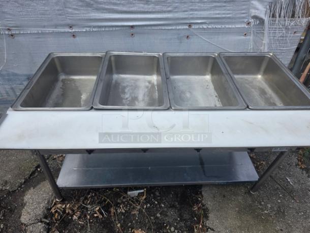 Avantco STE-4SA four-pan steam table with undershelf, stainless steel, open well design, used condition.
