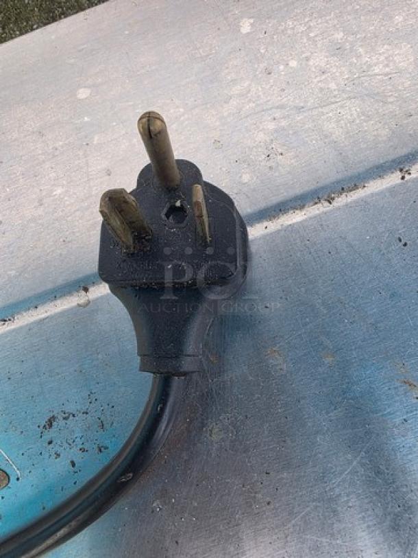 Alt text: Close-up of a power plug on an Avantco STE-4SA electric steam table.