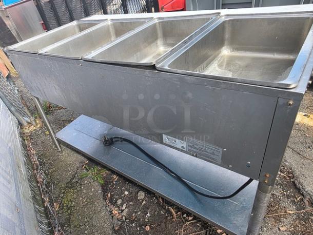 Avantco STE-4SA four pan electric steam table with undershelf, stainless steel, visible power cord, sturdy condition, ideal for catering.