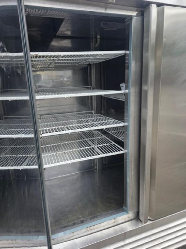Serv-Ware RR2 stainless steel refrigerator, two-door, commercial grade, on casters, adjustable shelves, clean interior.