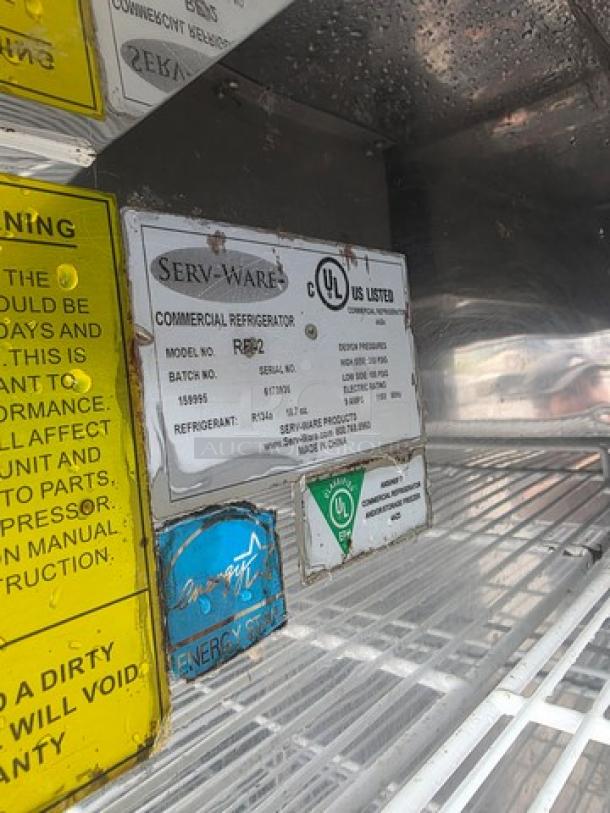 Serv-Ware RR2 commercial refrigerator interior, showing model and UL listing labels, energy efficiency sticker, clean metal shelves.