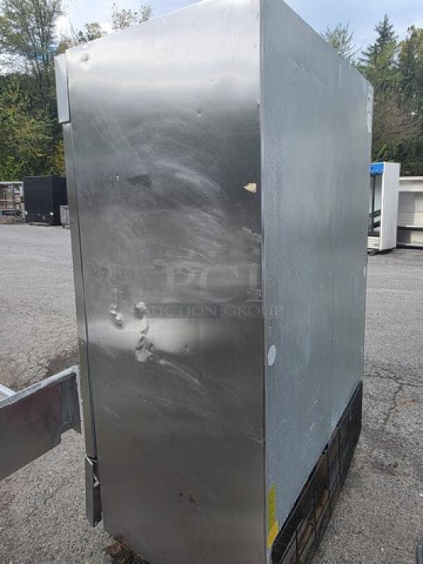 Serv-Ware RR2 2-door commercial stainless steel refrigerator on casters, visible dents, used condition.